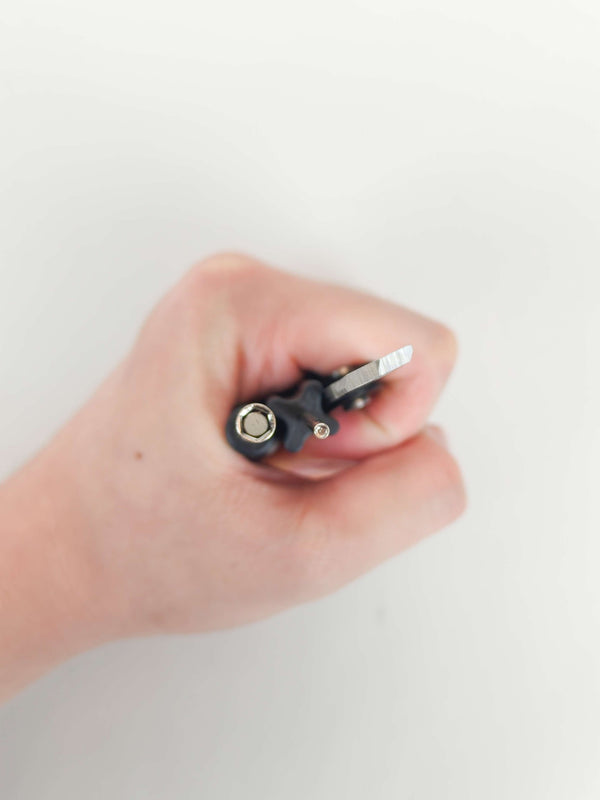 Folded carbon multi-scraper held in one hand to show its size